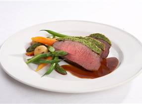 Roast of venison with herb crust and new vegetables